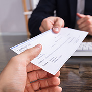 A person receiving a check from a banker.