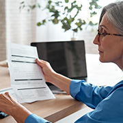 An older woman reviewing her finances.