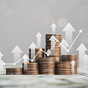Stacks of coins with rising arrows indicating increased profits.
